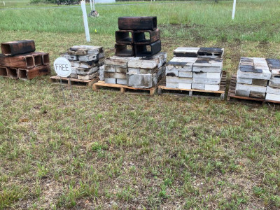 a row of blocks on pallets in a field