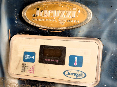 a close-up of a whirlpool jacuzzi control panel, dirty